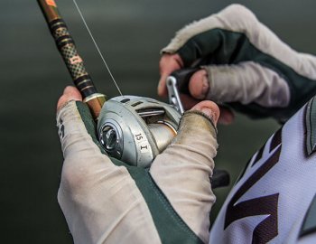 larry nixon holding fishing reel while worm fishing for bass